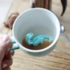House Of Disaster Turquoise Ombre Origami Dinosaur Mug 1 House Of Disaster Turquoise Ombre Origami Dinosaur Mug -Jellycat Christmas Store house of disaster turquoise ombre origami dinosaur mug 0v8a0013 900x900 1
